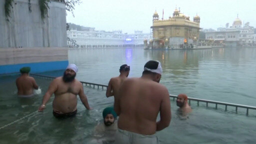 Hindu pilgrims take the risk and bathe in the river Ganges as part of a holy festival.